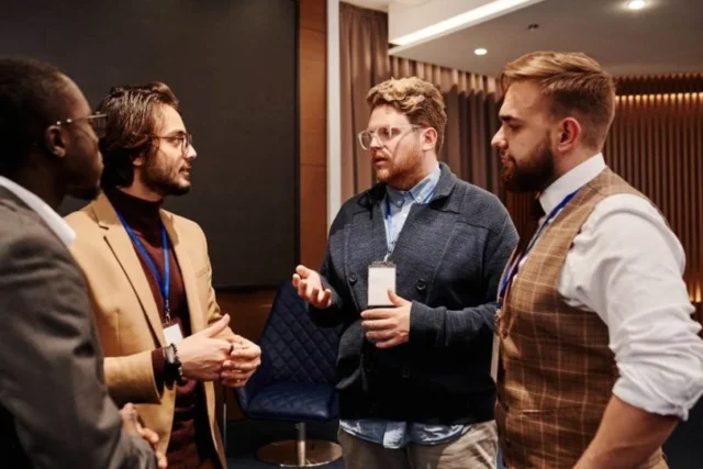 four men talking to each other