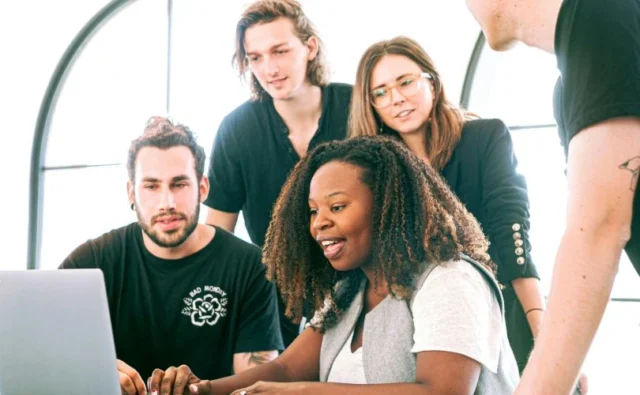 people brainstorming together with a laptop