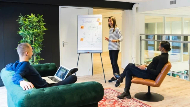three people brainstorming in an office
