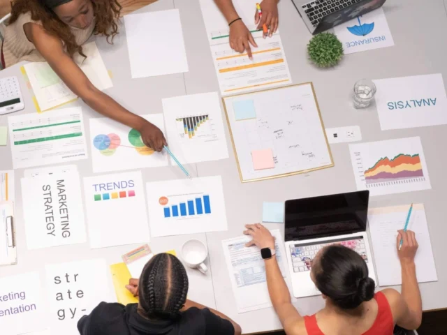 workers looking at marketing trends on a table